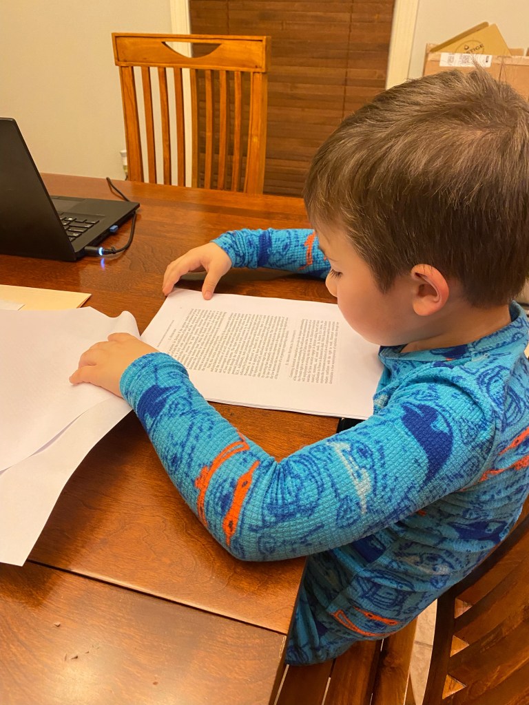 My son reading my published scholarship.